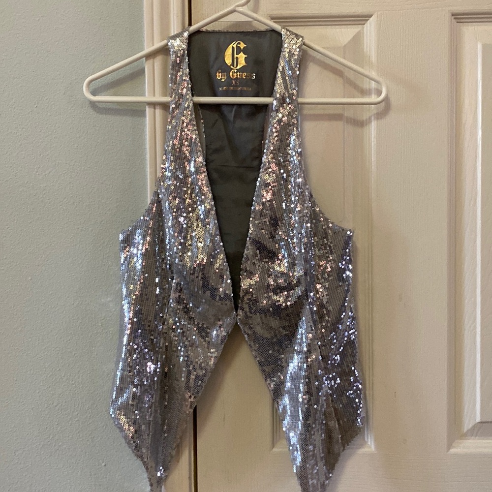 Silver sequin vest from Guess. Hook and eye closure in front.
